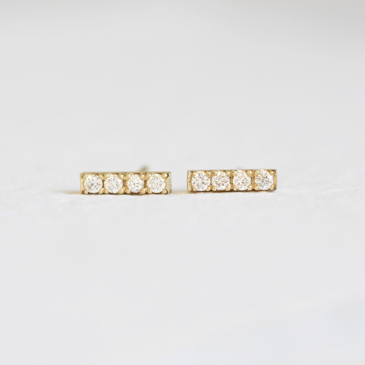 Hand Engraved By Rhode Island Jeweler, Corkie Bolton. This image is of 18k yellow gold bar studs with four diamonds in each earring.
