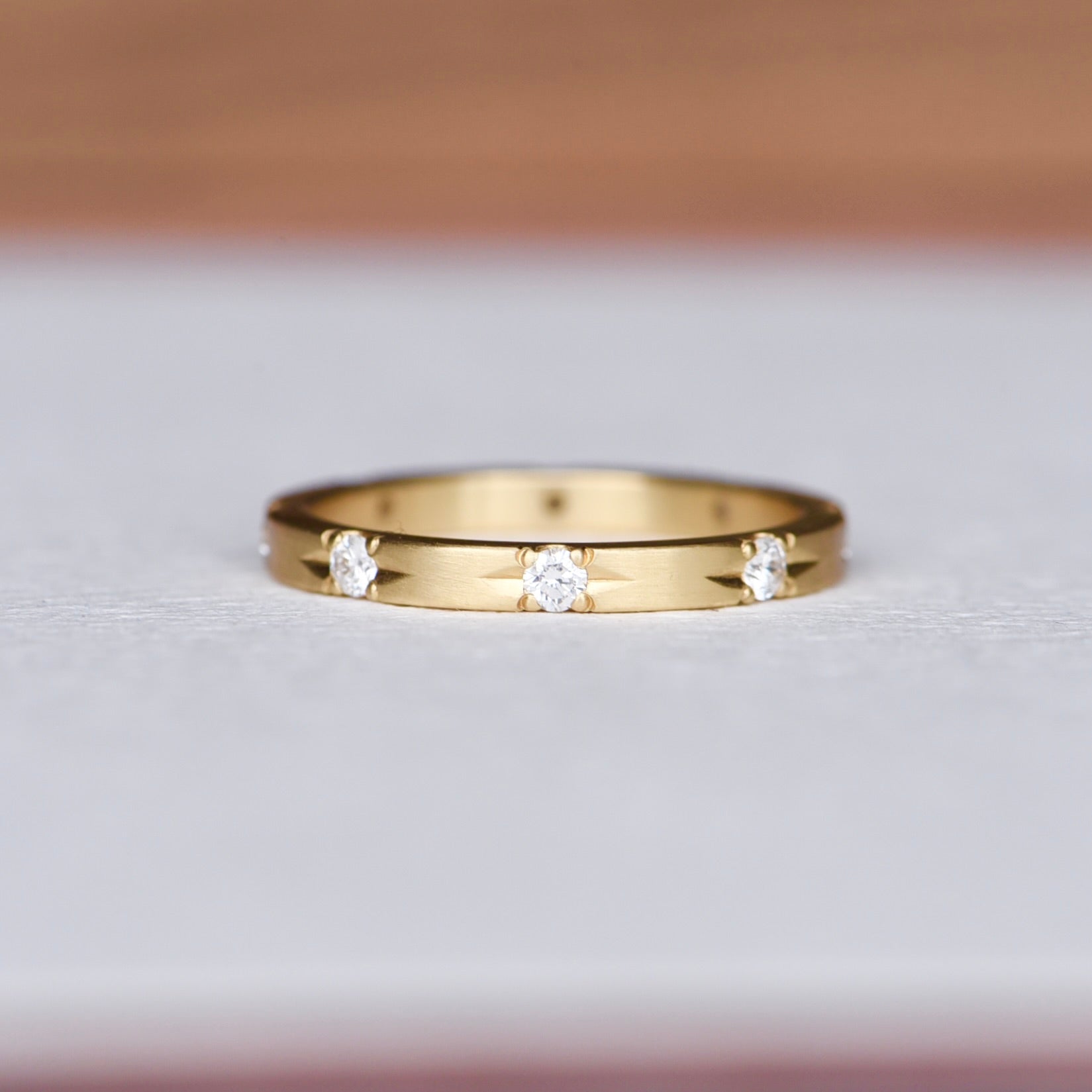 (Full View of Ring): Hand engraved 18k yellow gold Commitment Diamond Band featuring eight diamond star settings, crafted by Corkie Bolton Jewelry. Elegant and timeless design perfect for stacking or wearing solo.