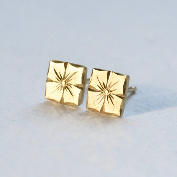 Hand engraved floral stud earrings in 18k yellow gold by Corkie Bolton Jewelry.