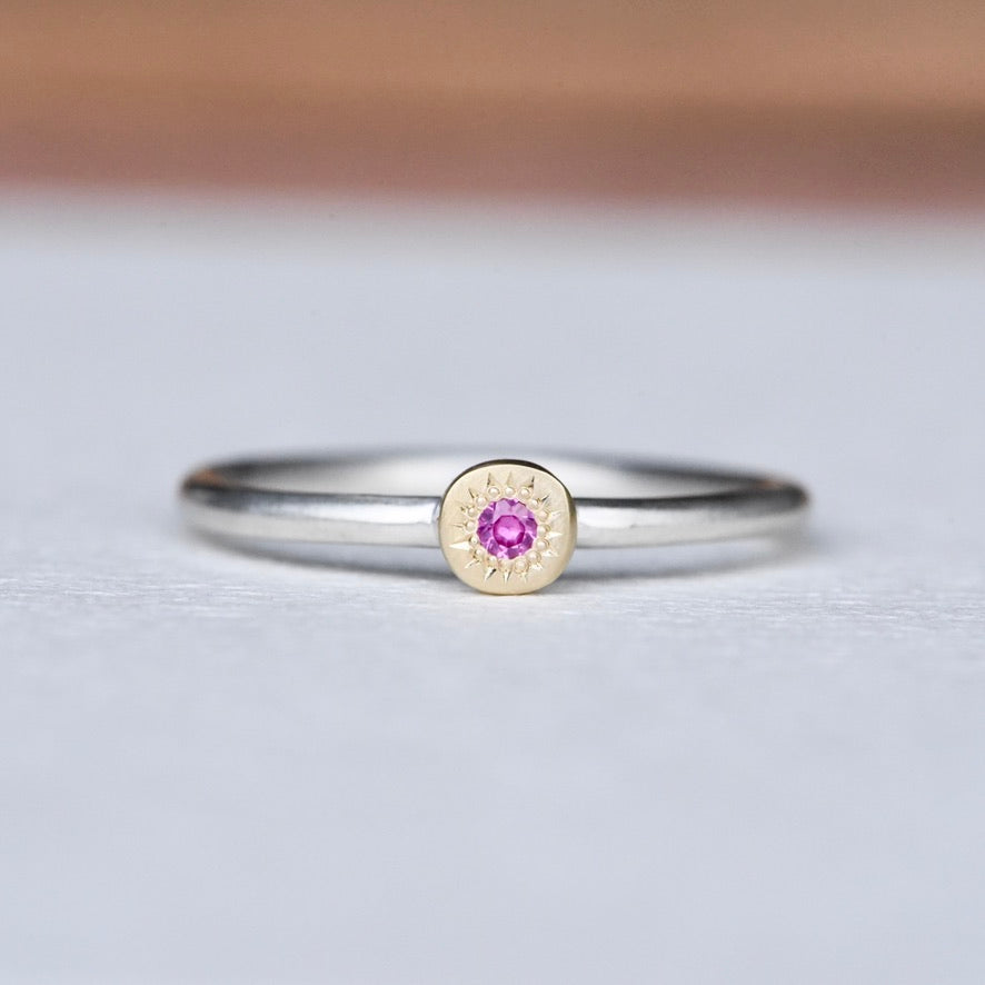 Handcrafted pink sapphire stacking ring in 14k gold and sterling silver, size 8.25, featuring a hand-engraved gold disc and satin finish band.