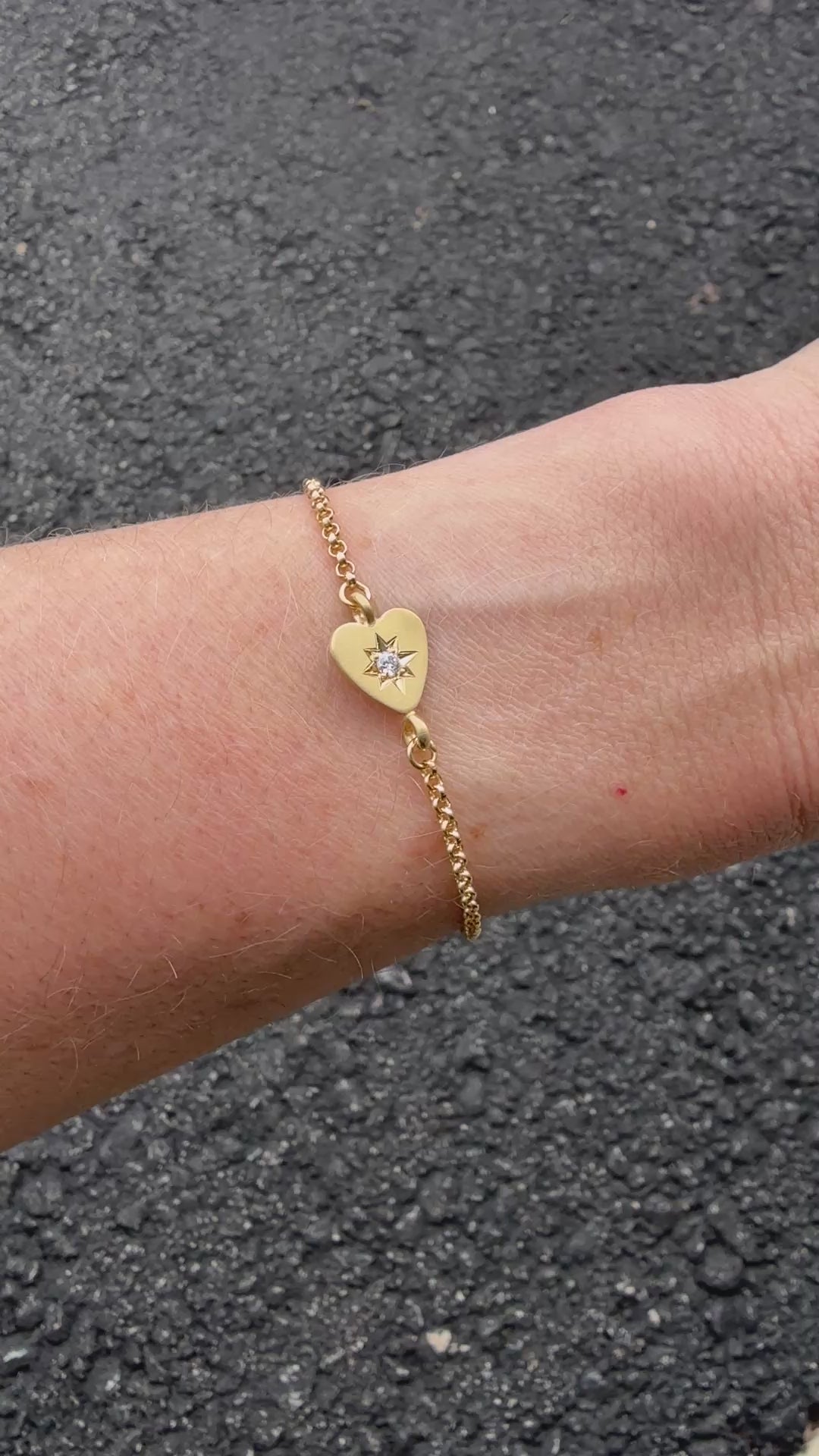 A short video clip showing the bracelet catching light as it moves, emphasizing the shine of the 18k gold and the sparkle of the diamond.