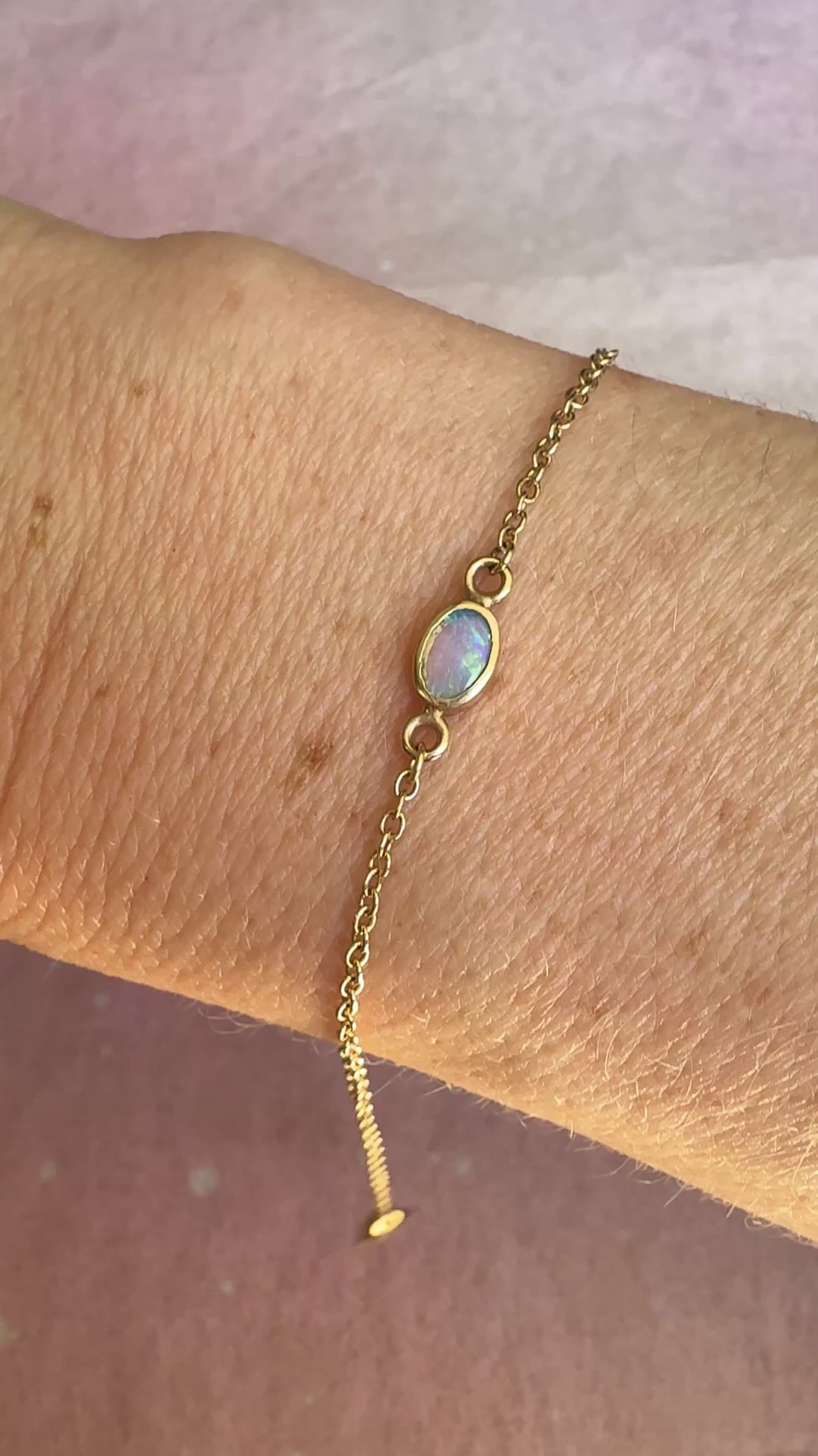 A video of the 14k gold opal bracelet showing shimmer, chain detail, and movement.