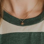 This retro-style, solid 14k yellow gold flower necklace is anything but subtle - sparkling with a small center diamond.
