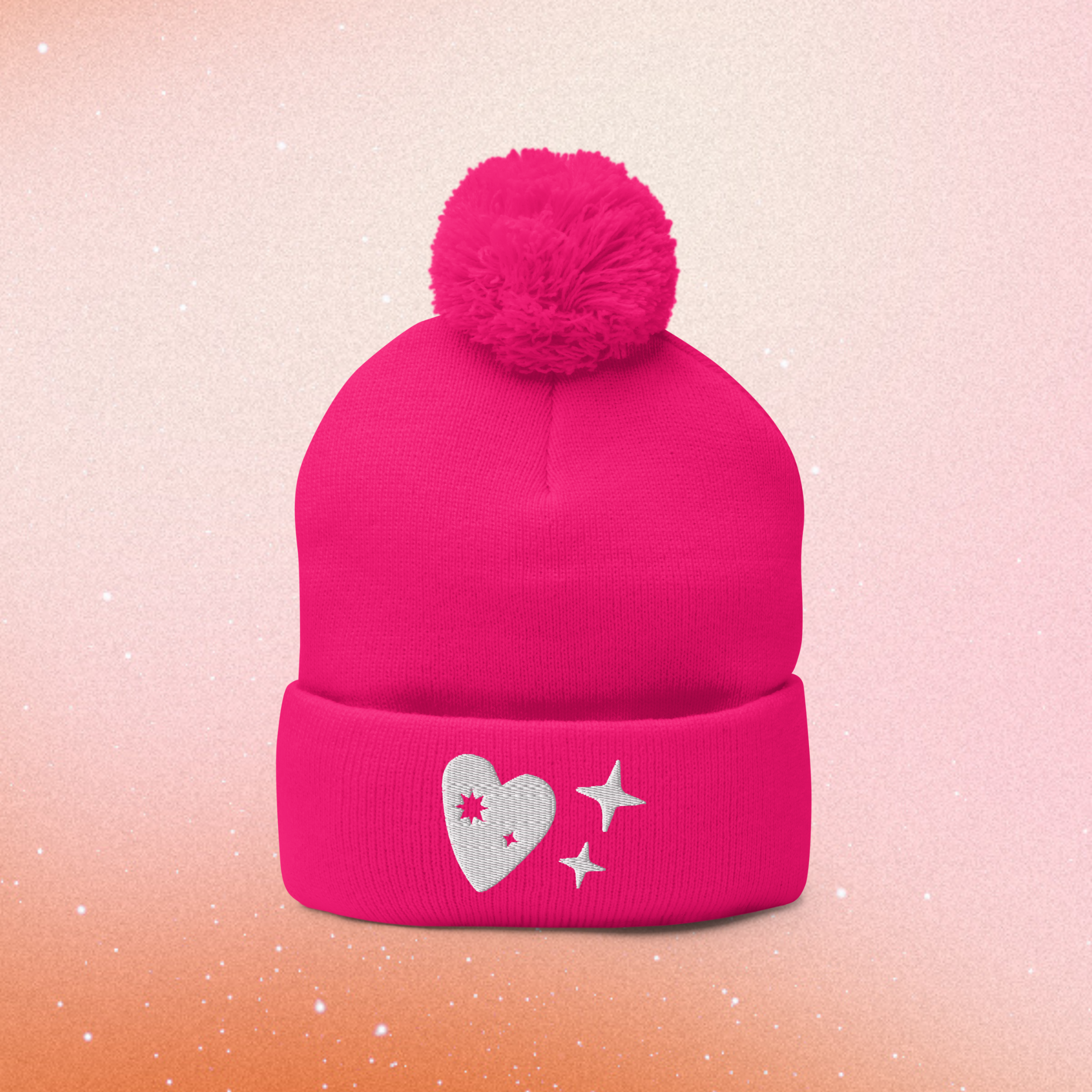 A blue fisherman beanie with gold thread embroidery of sparkles and additional charms.