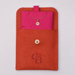 4k gold star-set diamond charm necklace displayed in a pink insert inside a branded CBJ jewelry pouch.