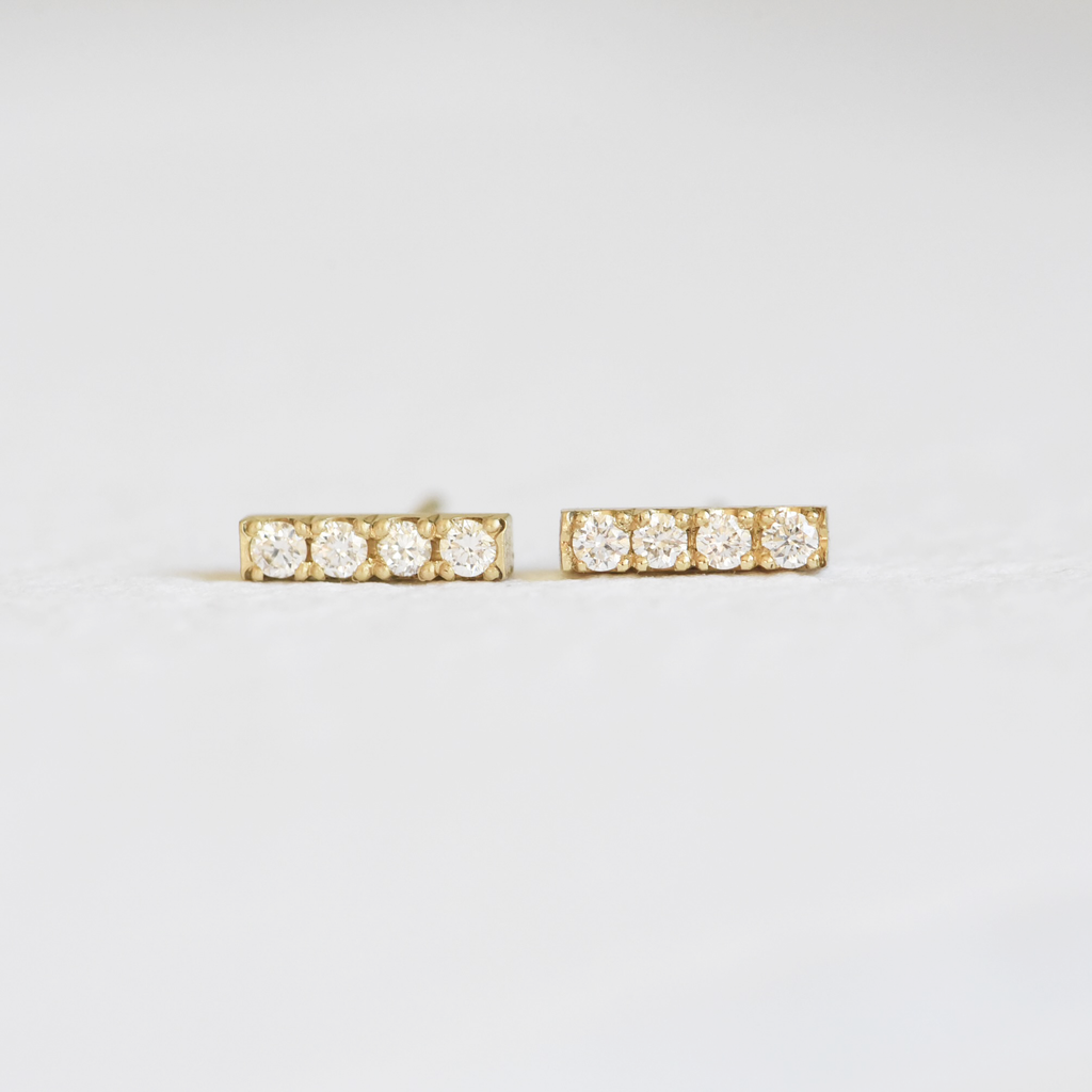 Hand Engraved By Rhode Island Jeweler, Corkie Bolton. This image is of 18k yellow gold bar studs with four diamonds in each earring.