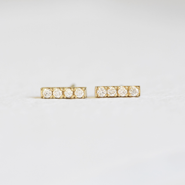 Hand Engraved By Rhode Island Jeweler, Corkie Bolton. This image is of 18k yellow gold bar studs with four diamonds in each earring.