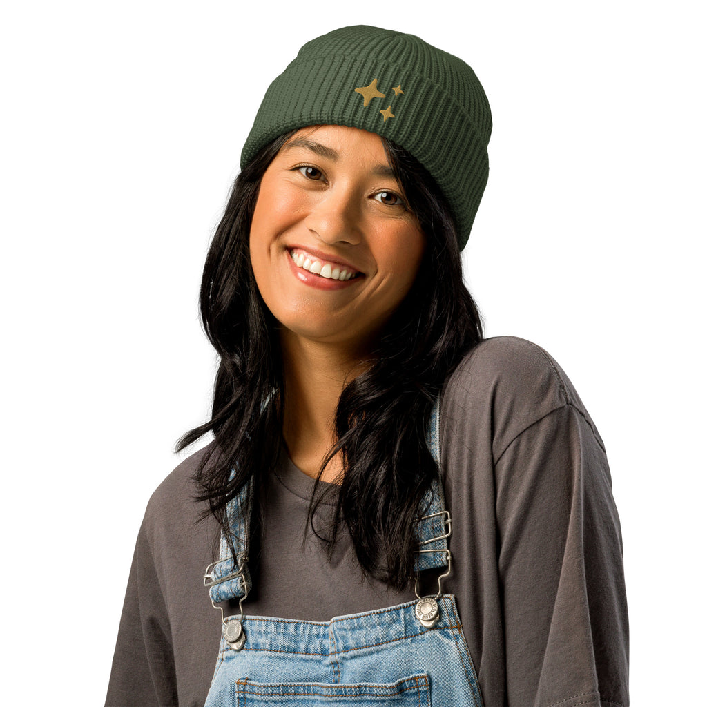 Cypress Green Sparkle Fisherman Beanie - soft ribbed knit beanie with delicate gold embroidered sparkle, perfect for a cozy and chic look. Being worn by a model in denim overalls. 