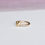 Side view of the ring highlighting the thickness and curvature of the puffed heart.