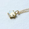 18k yellow gold six prong charm featuring moonstone.