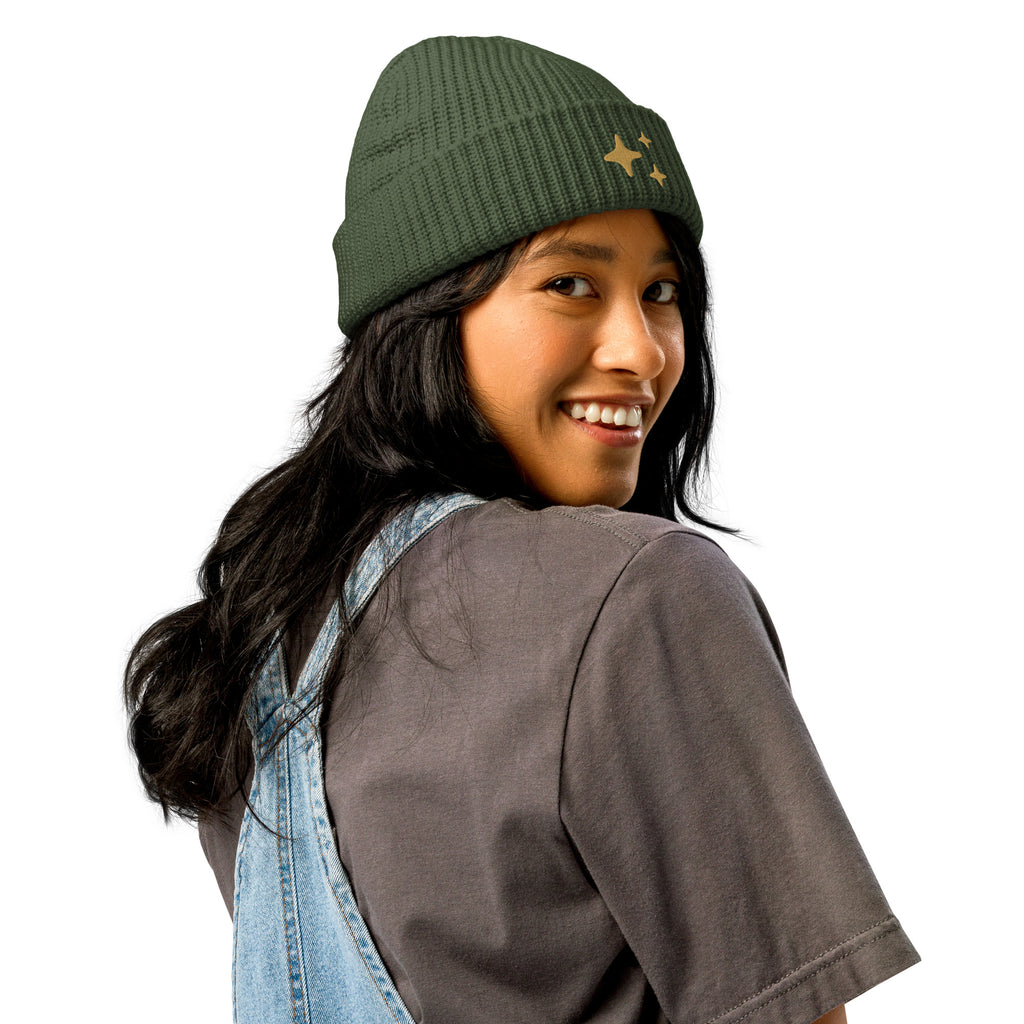 Cypress Green Sparkle Fisherman Beanie - soft ribbed knit beanie with delicate gold embroidered sparkle, perfect for a cozy and chic look. Being worn by a model in denim overalls. 