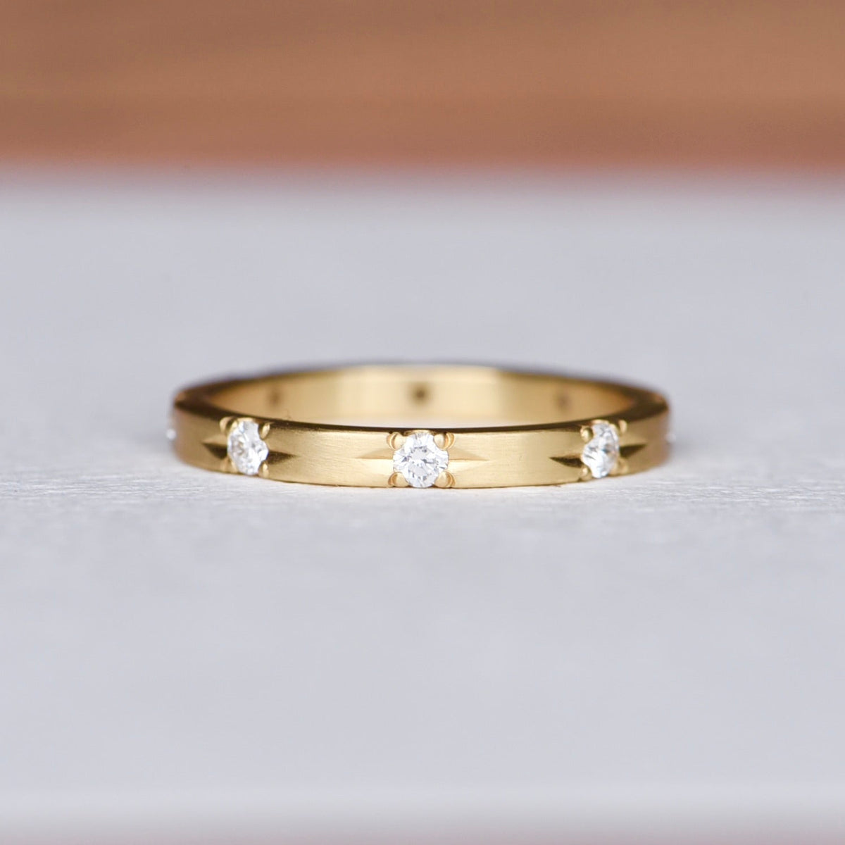 (Full View of Ring): Hand engraved 18k yellow gold Commitment Diamond Band featuring eight diamond star settings, crafted by Corkie Bolton Jewelry. Elegant and timeless design perfect for stacking or wearing solo.