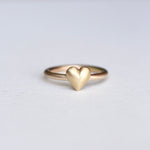  Close-up of the ring's heart shape from a unique angle, capturing its dimensionality.