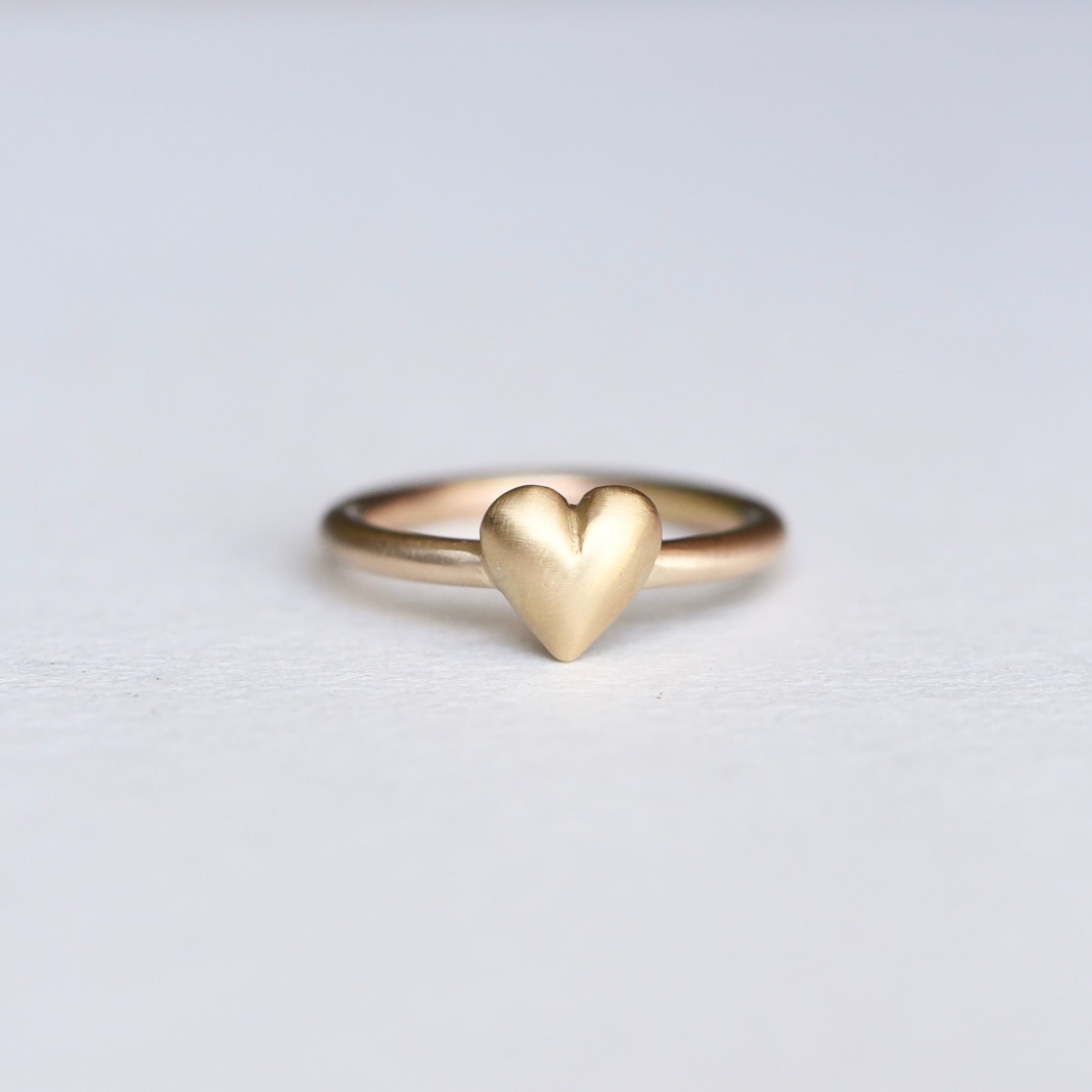  Close-up of the ring's heart shape from a unique angle, capturing its dimensionality.