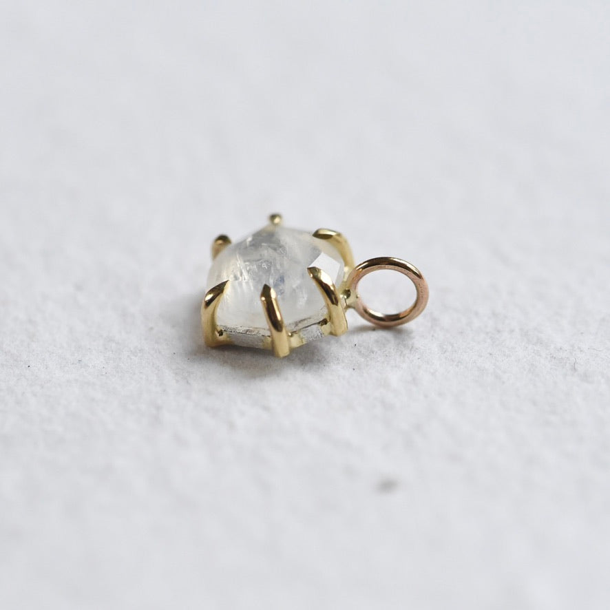 18k yellow gold six prong charm featuring moonstone.