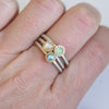 London Blue Topaz Stacker ring along with a moonstone stacker and a Chrysoprase stacker on a hand, Showcasing the vibrant gemstones set in warm 14k gold with a thin satin finish band.