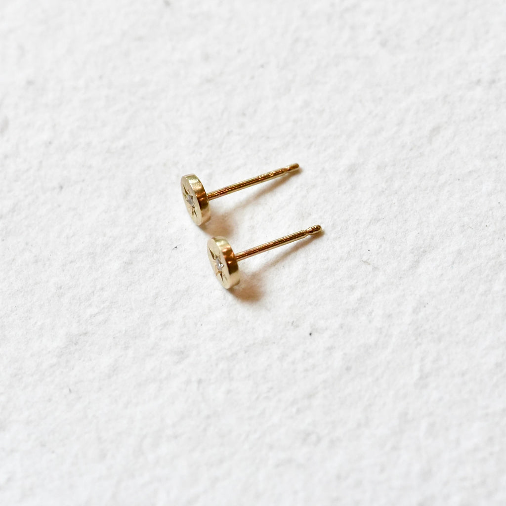 Side profile of petite, celestial hand engraved 14k gold and diamond stud earrings by Corkie Bolton Jewelry