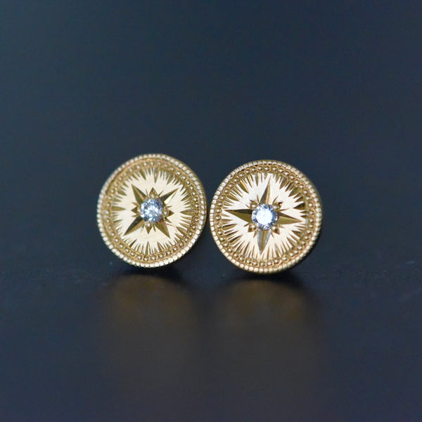 14k yellow gold circular stud earrings that are hand engraved with diamonds set in a star setting by Corkie Bolton Jewelry.
