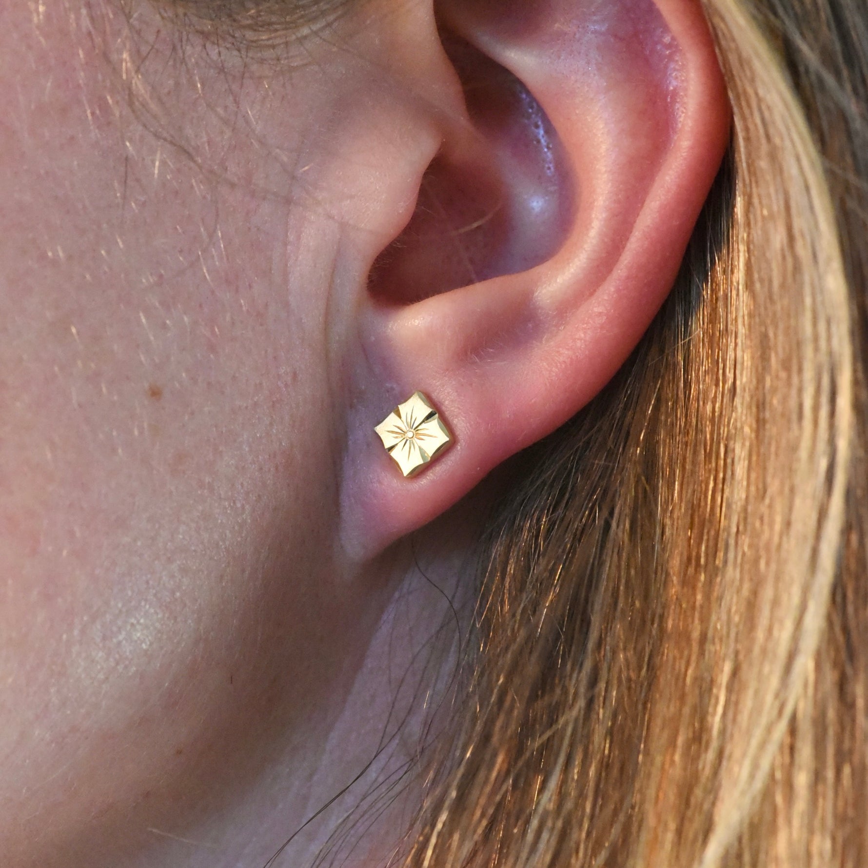 Hand engraved floral stud earrings in 18k yellow gold by Corkie Bolton Jewelry.