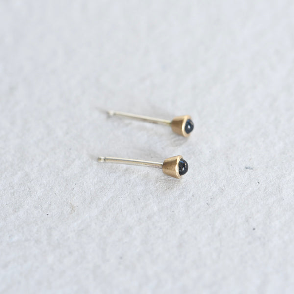 Mixed metal, gold and silver blue sapphire studs.