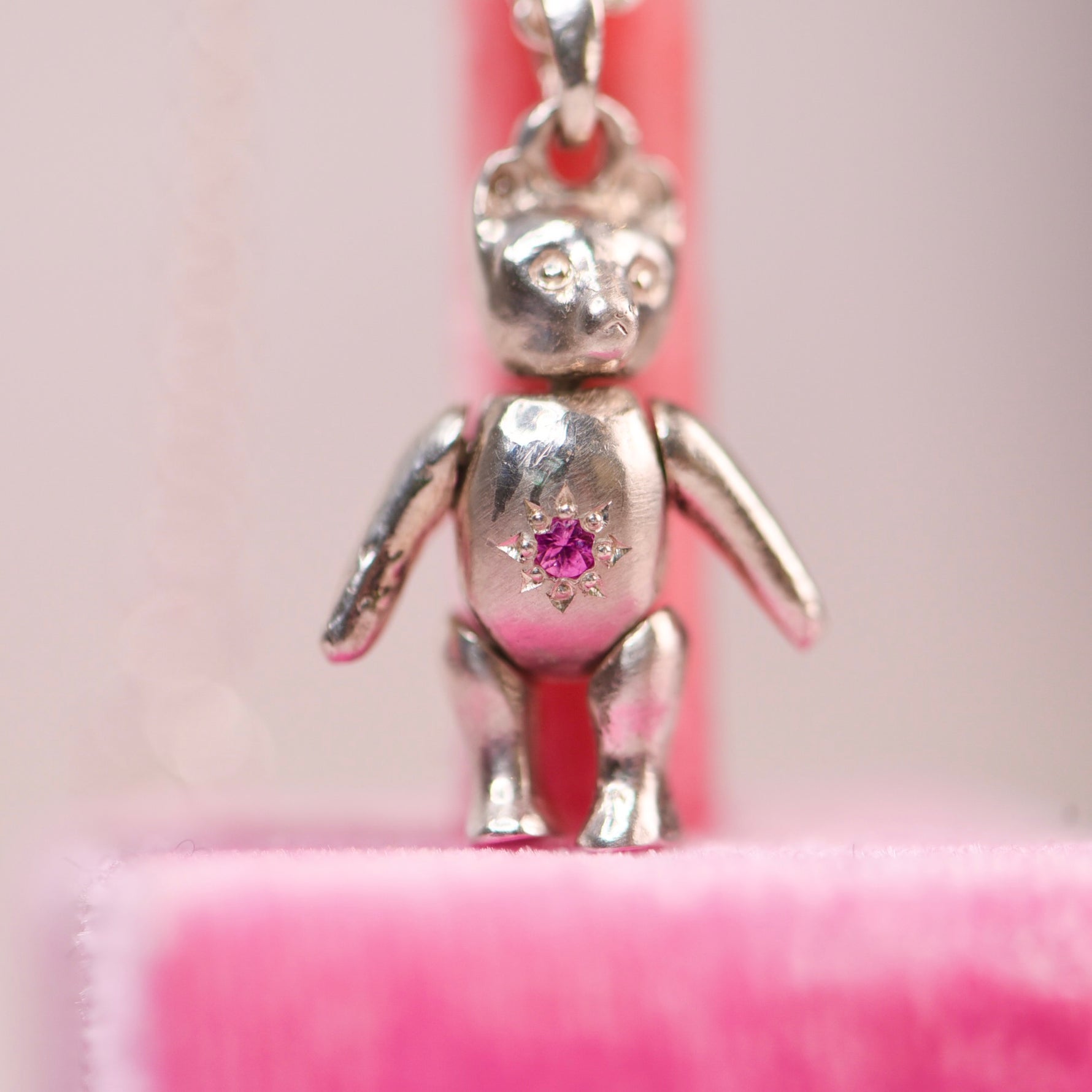 Vintage mid-century sterling silver teddy bear pendant with hand engraved pink sapphire star setting