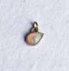 A teardrop flashy opal set in 14k gold as a charm, created by Corkie Bolton Jewelry.