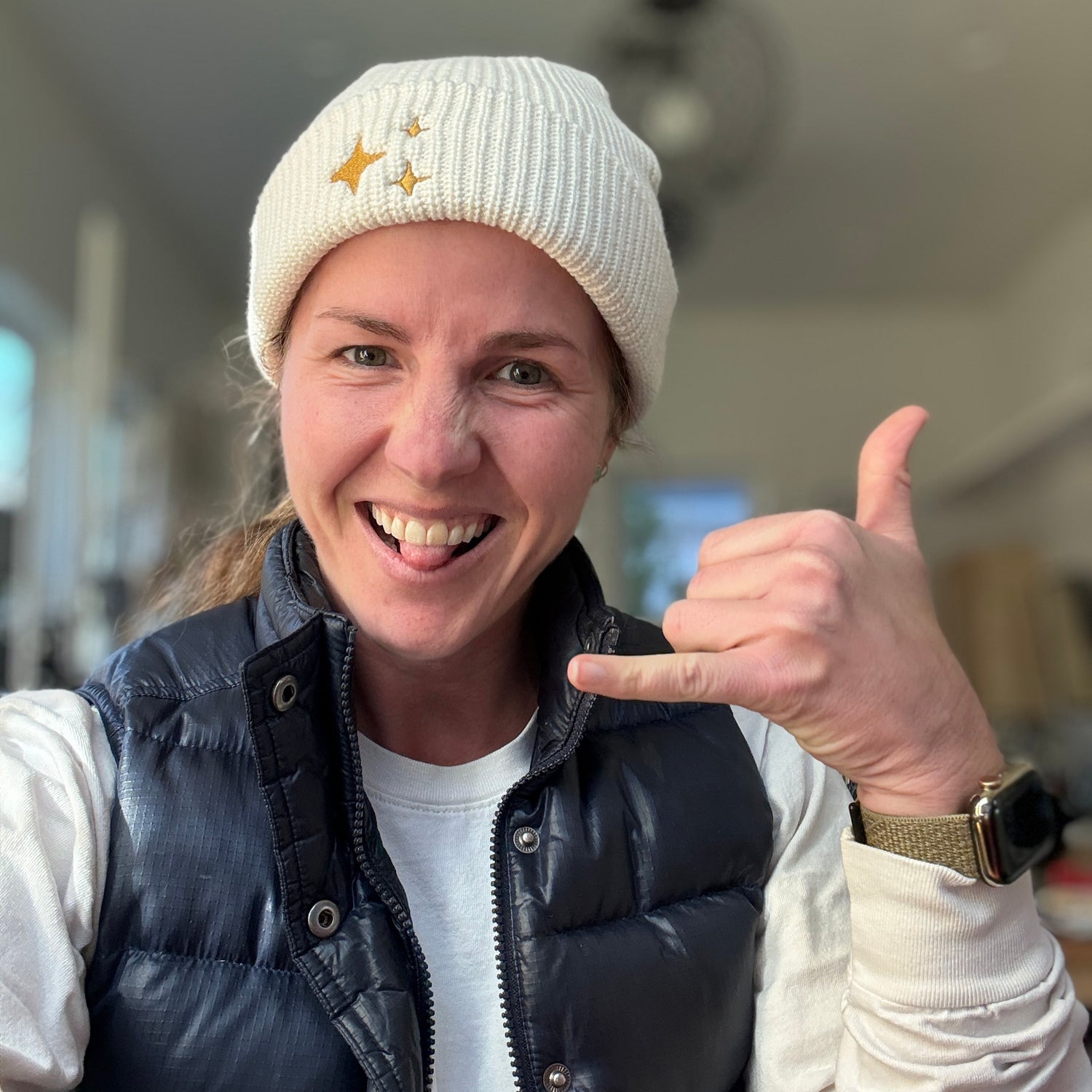 Ecru Sparkle Fisherman Beanie - soft ecru-colored ribbed knit beanie with delicate gold embroidered sparkle, perfect for a cozy and chic look. Being worn by jewelry Corkie Bolton. 