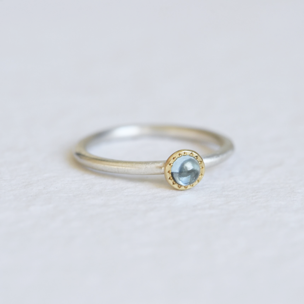 London Blue Topaz Stacker ring on a white background, featuring a deep blue topaz gemstone in a 14k gold bezel with a slim, polished band.