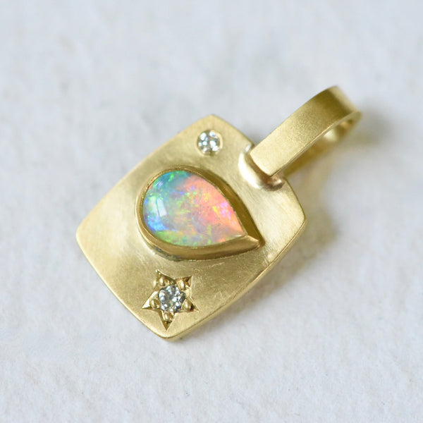 !8k yellow gold rectangular charm with a pear shaped Coober Pedy Australian Opal and diamonds. Hand engraved.