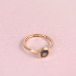 Inside of a gold ring band engraved with “Mom, Always With Me” in script lettering