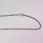 Close-up of the oxidized sterling silver rolo chain from the HELL YES Misfit Heart Necklace, adjustable to 16", 18", or 20", handcrafted by Corkie Bolton Jewelry.