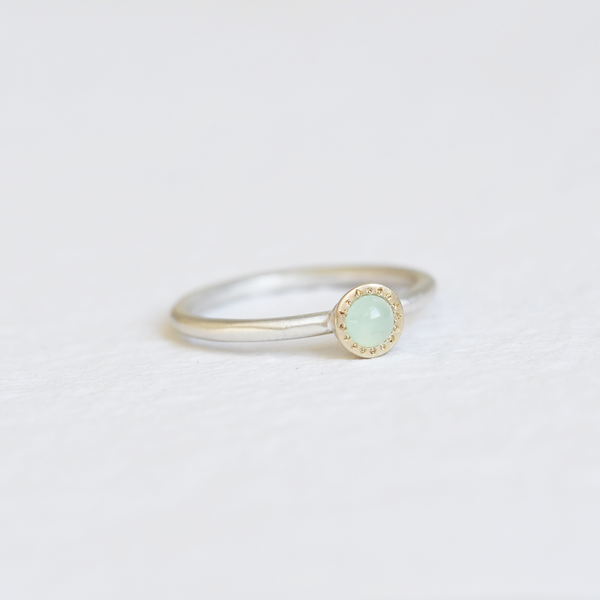 Stacking ring with a Chrysoprase set in a gold bezel with a satin finish silver band.