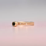 Gold ring with hand engraved cosmic diamonds on a gradient background