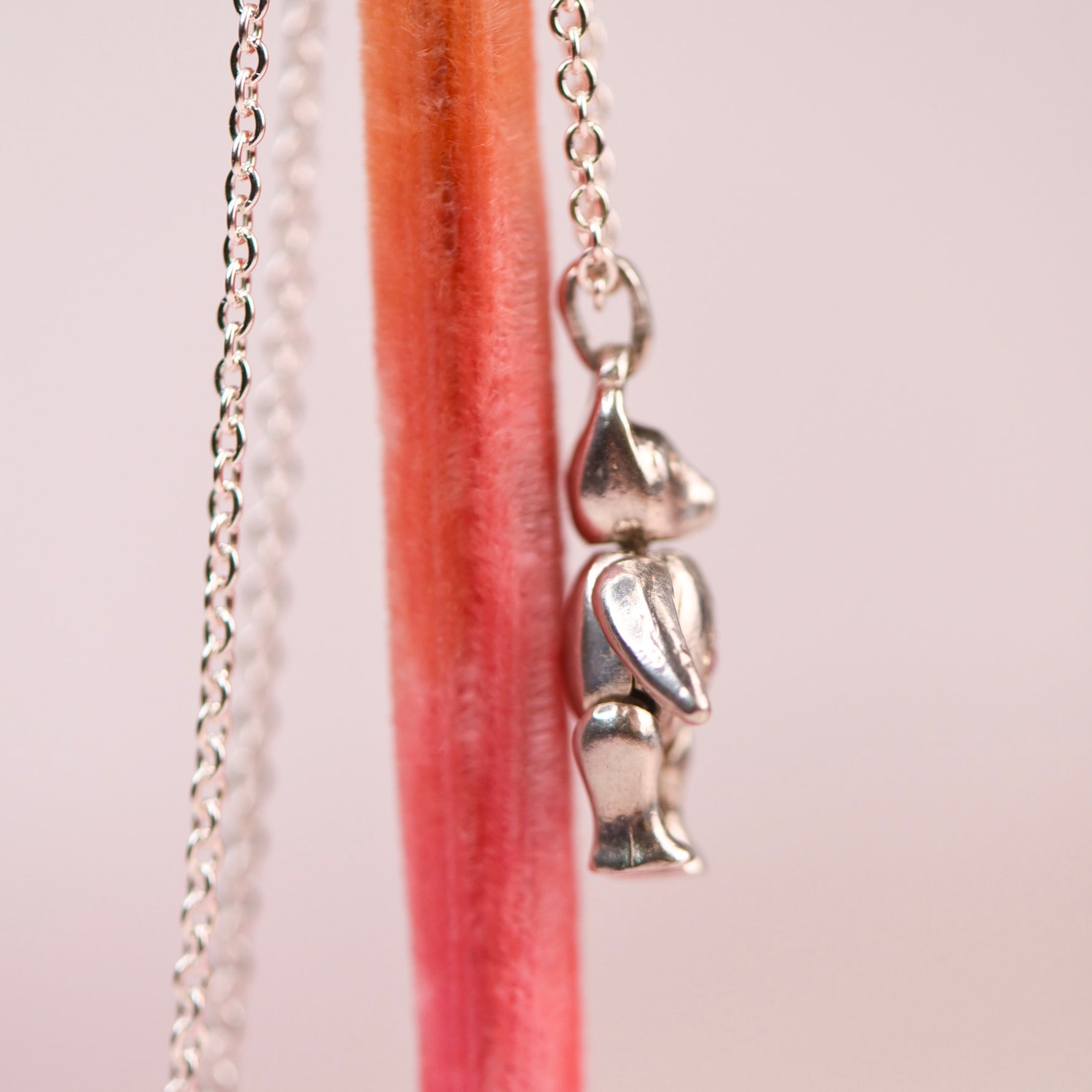 side profile view of vintage sterling silver articulating teddy bear charm on cable chain