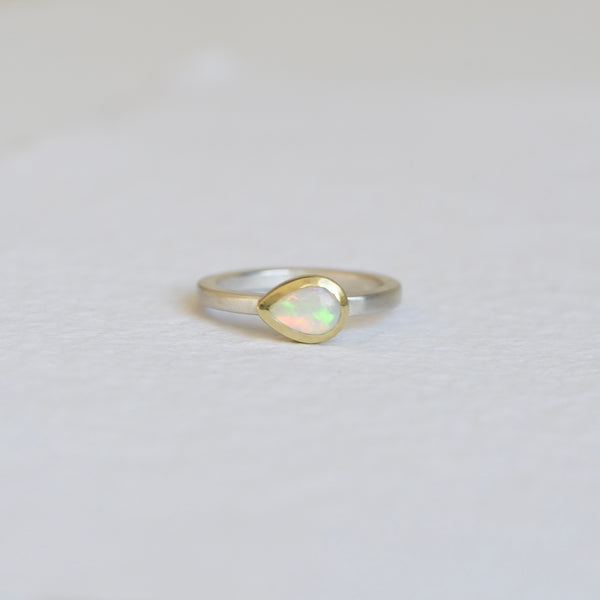 Australian Opal Teardrop Ring on a white background, featuring a vibrant teardrop-shaped opal set in a 14k gold bezel with a satin finish band