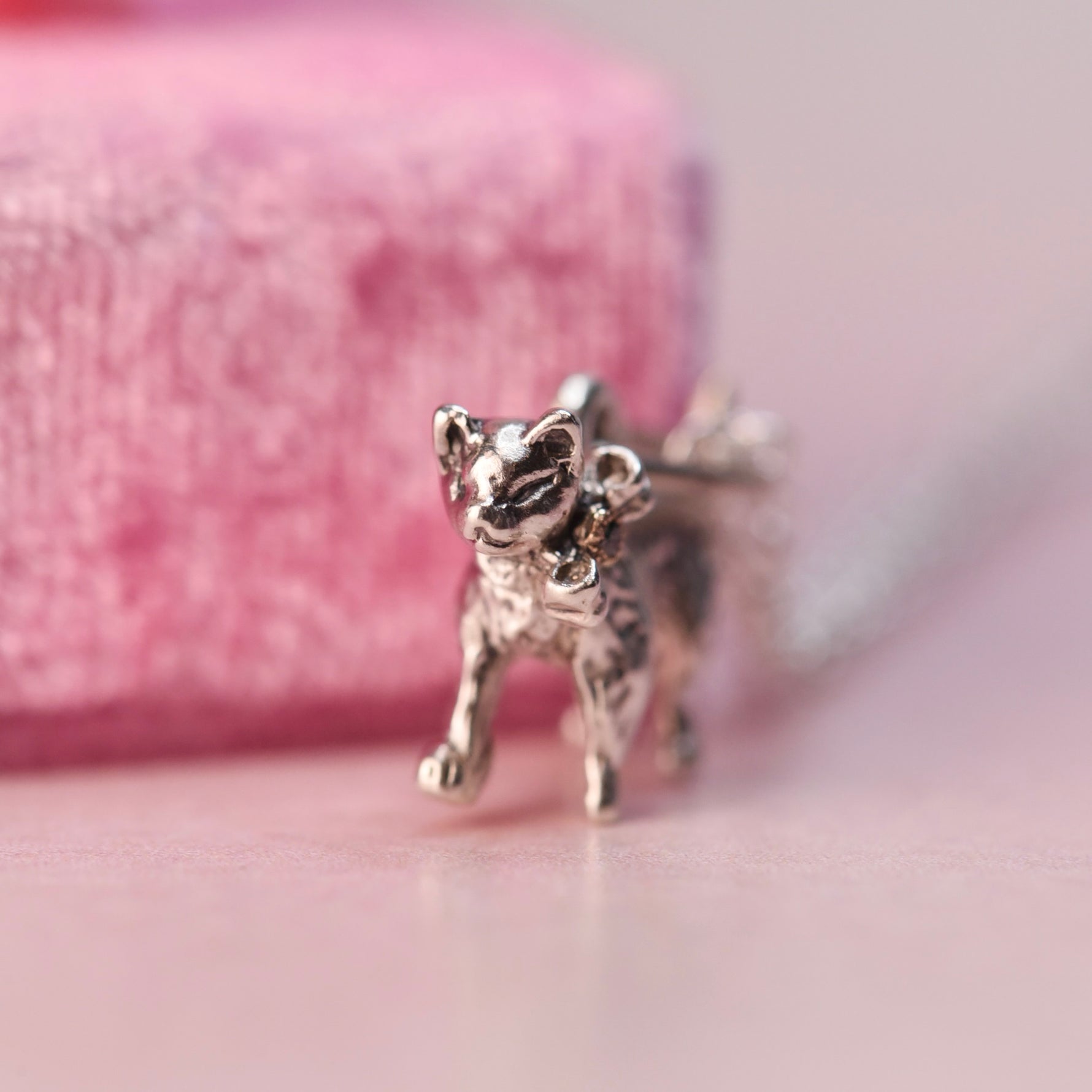 Face detail of a mid-century Beaucraft sterling silver kitten charm showing sculpted vintage craftsmanship