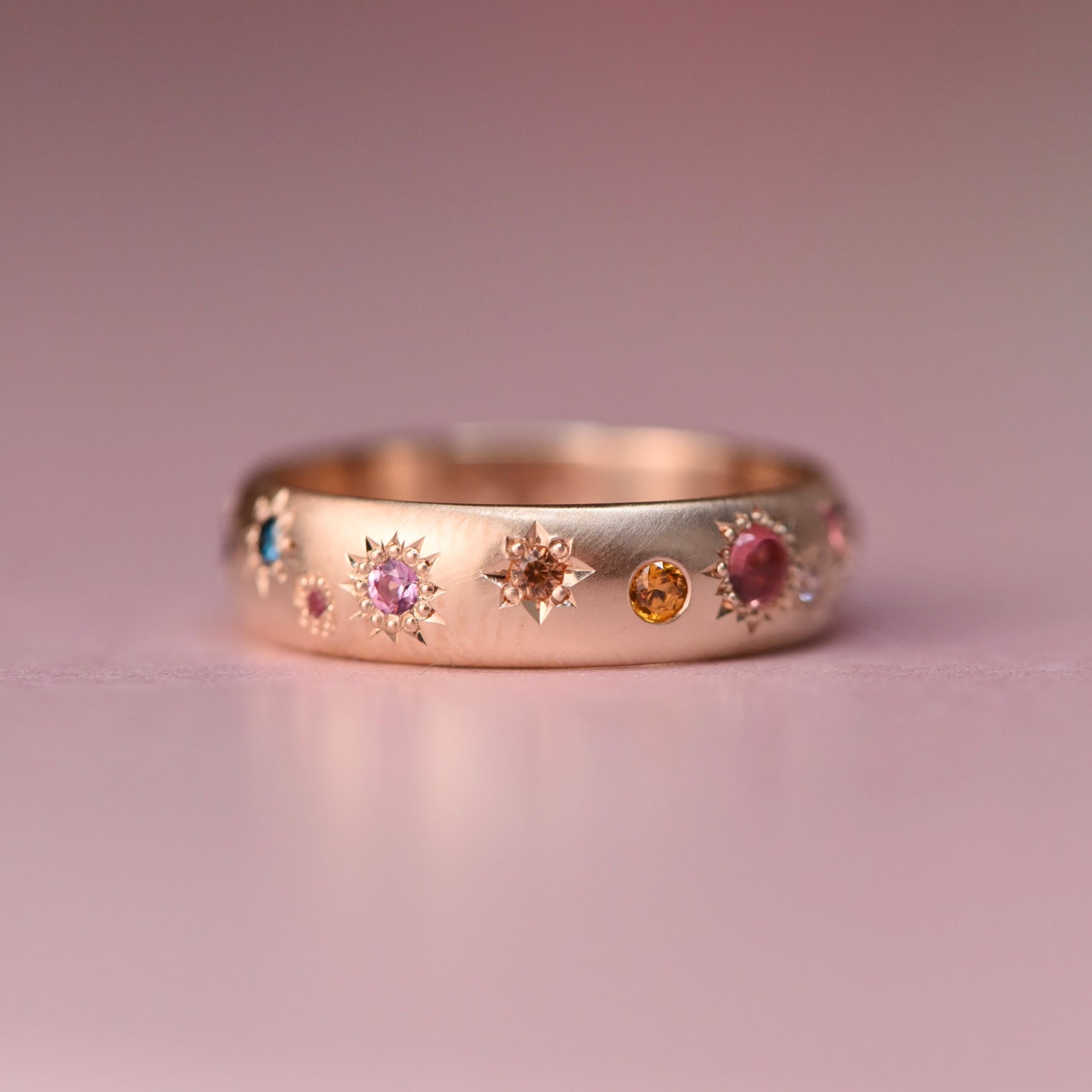 One-of-a-kind Confetti Band with multicolor sapphires and diamonds star-set around a 10k gold vintage wedding band, part of the Reborn Vintage Collection.