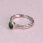 Interior view of the silver ring band showing the “CBJ” maker’s mark alongside the green tourmaline bezel setting.
