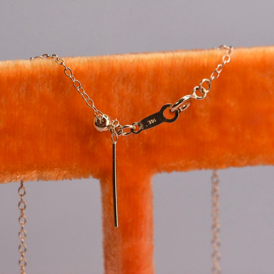 Detail of adjustable extender on 14k yellow gold chain for rose cut salt and pepper diamond necklace