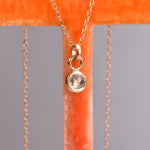14k yellow gold bezel-set rose cut salt and pepper diamond necklace shown from the back with star engraving on the pendant