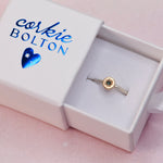 Engraved Starburst Silver and 14k Gold Sapphire Ring displayed in a Corkie Bolton Jewelry box with blue hot foil heart logo, highlighting the hand-engraved star setting.