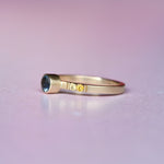 Side profile of handcrafted Montana sapphire ring in 10k gold, showcasing the gradient of orange to deep pink sapphires with intricate milgrain and durable gold band.