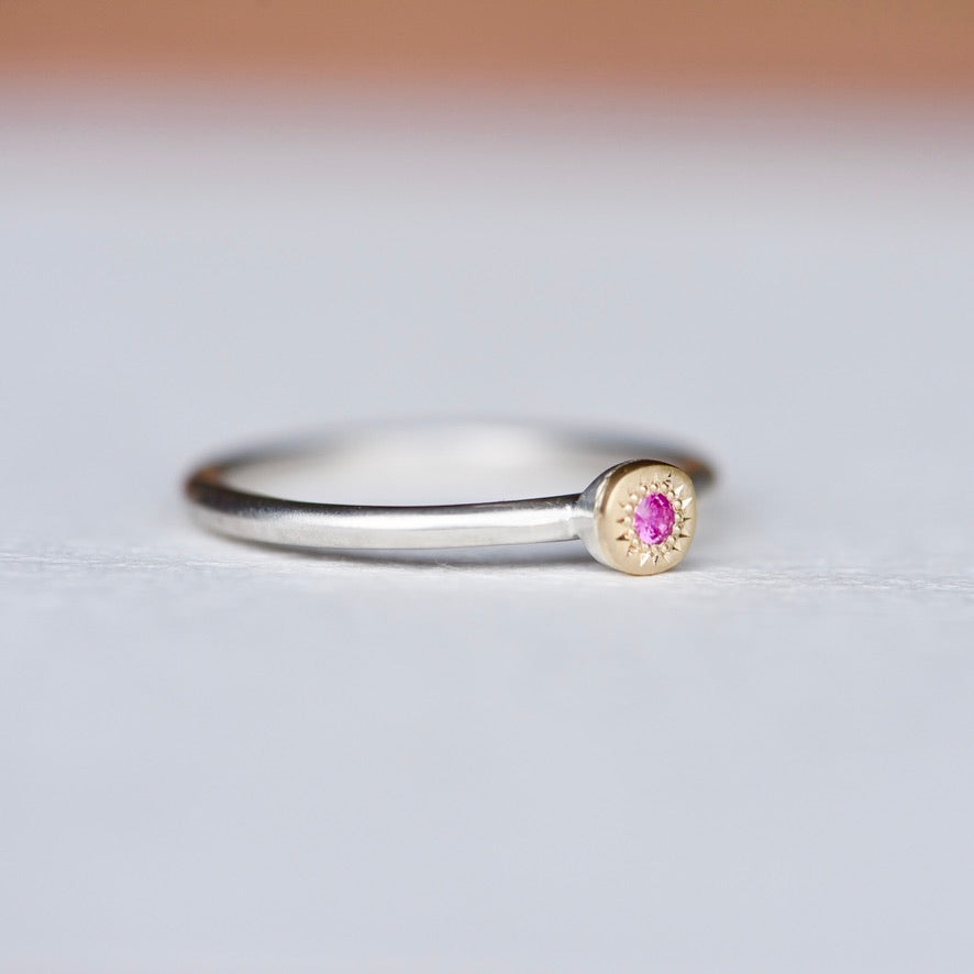 Side view of pink sapphire 14k gold and sterling silver stacking ring, showing slim recycled silver band with satin finish and engraved gold disc detail.