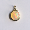 18k yellow gold charm featuring a gorgeous Ethiopian Opal that is responsibly sourced. Created by Corkie Bolton Jewelry.