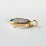 Handmade 22k yellow gold bezel set Lightning Ridge crystal opal pendant, fine silver back, by Corkie Bolton Jewelry Rhode Island on a white background
