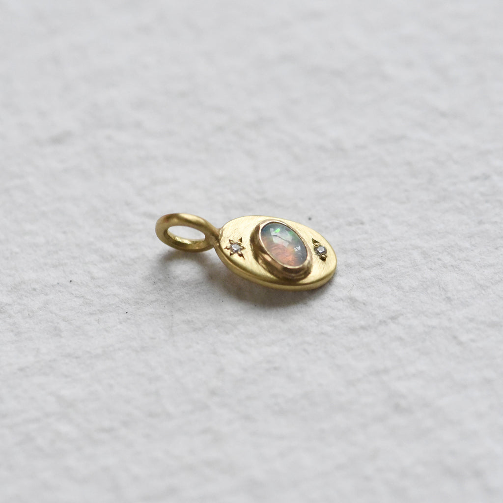 18k yellow gold hand engraved charm with opal and diamonds by Corkie Bolton Jewelry.