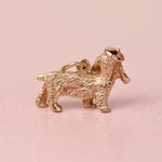 Back view of a mid-century 14k gold cocker spaniel charm showing the textured coat, bail, and hand fabricated rose gold beret