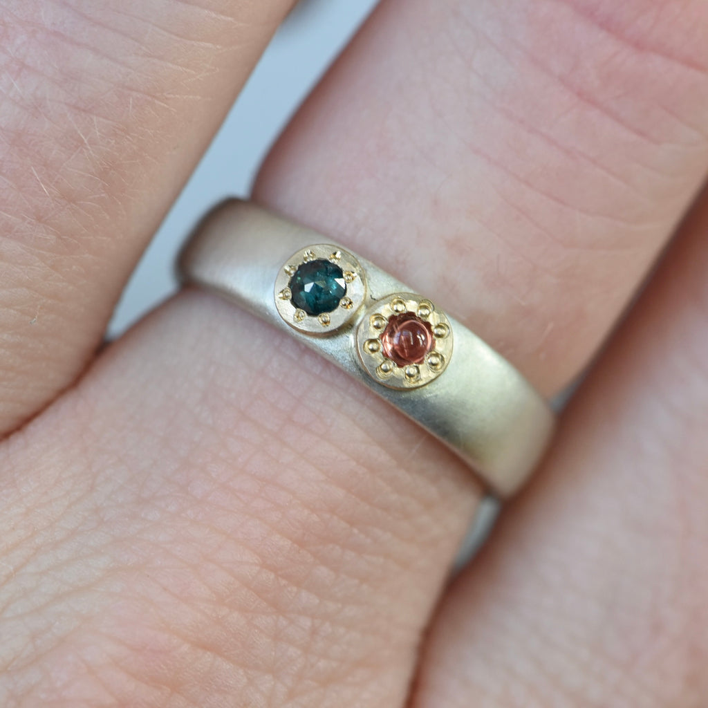 Orange sapphire and green diamond ring.