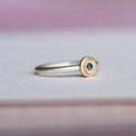 Side view of the Engraved Starburst Ring showing the mixed-metal design with sterling silver band, 14k gold star setting, and engraved details surrounding the blue sapphire.