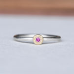 Handcrafted pink sapphire stacking ring in 14k gold and sterling silver, size 8.25, featuring a hand-engraved gold disc and satin finish band.